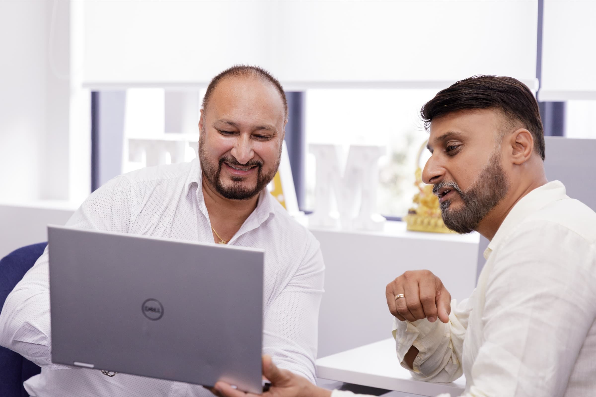 Two Newpark advisers reviewing a plan on a laptop